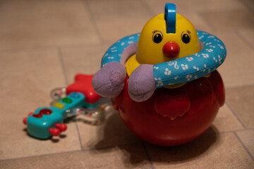 Chicken toy with guitar on background.