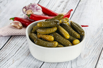 Marinated small cucumbers in the bowl