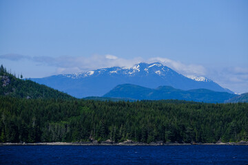 Panoramic morning or day time landscape nature coastal scenery with beautiful blue sky and dramatic cloudscapes in Alaska Inside Passage glacier mountain range view