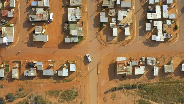 Drone, houses and cars in township with infrastructure, informal settlement or village landscape. Community, poverty and road with buildings and transport, location in South Africa with aerial view