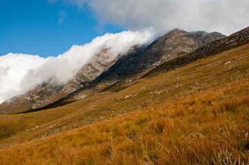 Dramatic clouds and mountains, ragged peaks in natural landscape in the Outeniqua mountains in the fynbos region of the western cape 