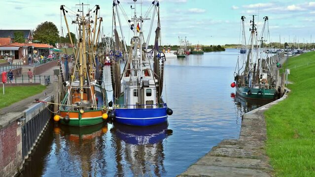 Fish boats in the Small idyllic harbor of Greetsiel-Krummhörn, north sea, Germany