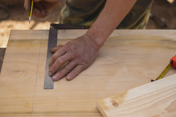 Carpenter measuring wood furniture work