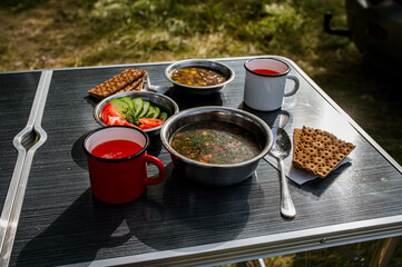 lunch in nature: soup, juice and vegetables
