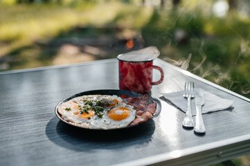 scrambled eggs with bacon and fragrant coffee in a red mug