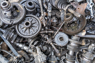 pile of used car transmission gears, full-frame close view background.
