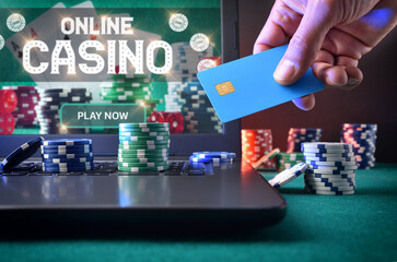 Casino game player betting online with laptop front view