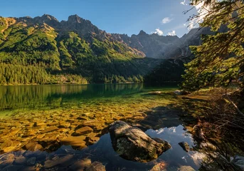 Cercles muraux Tatras Beautiful, colorful mountain lake with an azure surface and mountain peaks with beautiful sunlight. Morskie Oko - Eye of the Sea - Tatry - Tatra Mountains.Polska Most beautiful places in Poland Polska