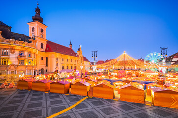 Fototapeta na wymiar Sibiu, Romania. Christmas Market in Large Square, medieval downtown of Transylvania, famous European Xmas Fair.