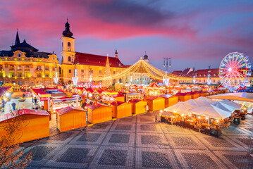Fototapeta premium Sibiu, Romania. Christmas Market in Large Square, medieval downtown of Transylvania, famous European Xmas Fair.