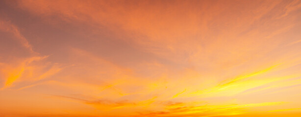 Sunset Sky on Twilight in the winter Evening with Orange Gold Sunset Cloud Nature Colorful Sky Backgrounds, Horizon Golden Sky, Gorgeous.