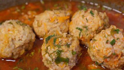 Meatballs in sauce and herbs.
