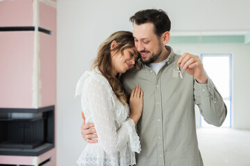 Emotional love concept delighted woman and man husband and wife buying new house apartment...