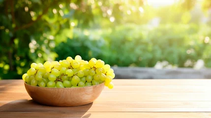 Gordijnen Grapes in a bowl against the backdrop of the garden. Selective focus. © yanadjan