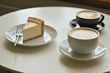 two cups of coffee latte with cake