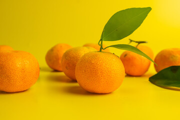 Fresh and ripe oranges on a yellow background. Concept photo.