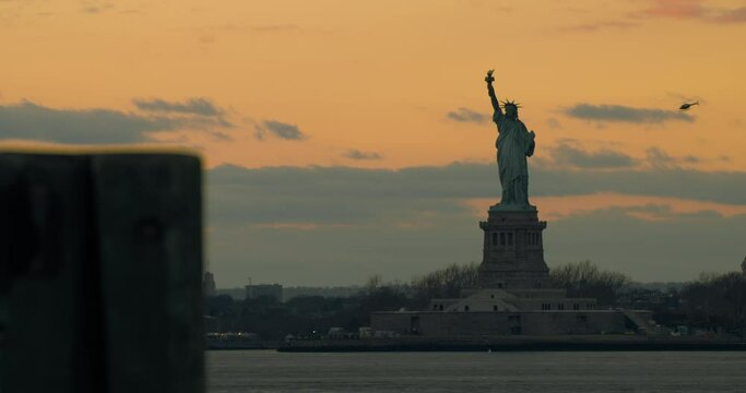 Boat and Air Traffic in New York Bay with Statue of Liberty at Sunset