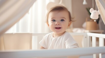 Fototapeta premium A cute little 1-2 year old baby with blonde hair is standing in a crib and laughing. Happy childhood. Kids's emotions