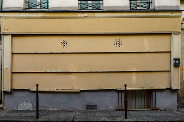 old metal shutter on french boutique facade