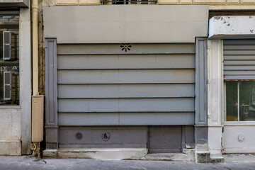 old metal shutter on french boutique facade