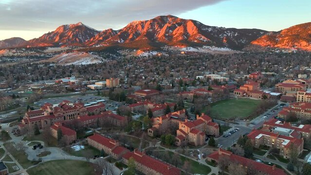 Beautiful Aerial Drone Sunrise over the University of Colorado Boulder (CU Boulder) with flat irons foothill mountains in background on a winter morning.
