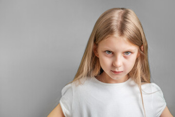 Portrait of sad little girl in white t-shirt