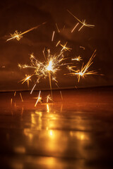 sparkler on a dark background with sparks