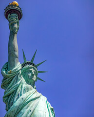 Fototapeta premium The Statue of Liberty holding its torch is the democratic symbol of New York (USA) and the Big Apple, famous in Manhattan and around the world.