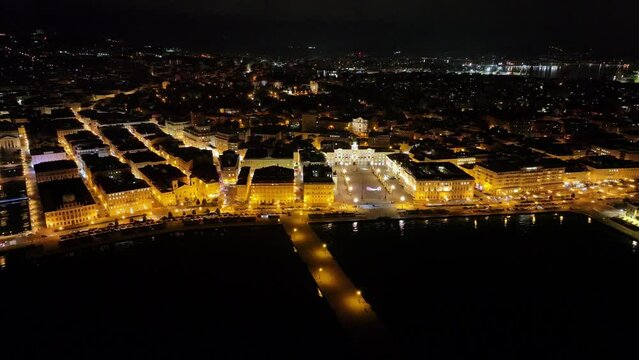 drone shot of trieste at night on the seaside