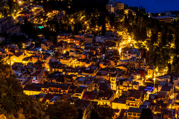 Beautiful view of night town of Italy with colorful golden lights, night landscape on city of Europe