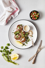Mediterranean Inspired Vegan Falafel Meal with Lemon and Greens, Restaurant Presentation on gray background 