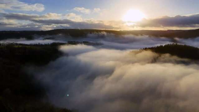 sunrise drone video of landscape above the clouds with fog and mist in the hills of Belgium