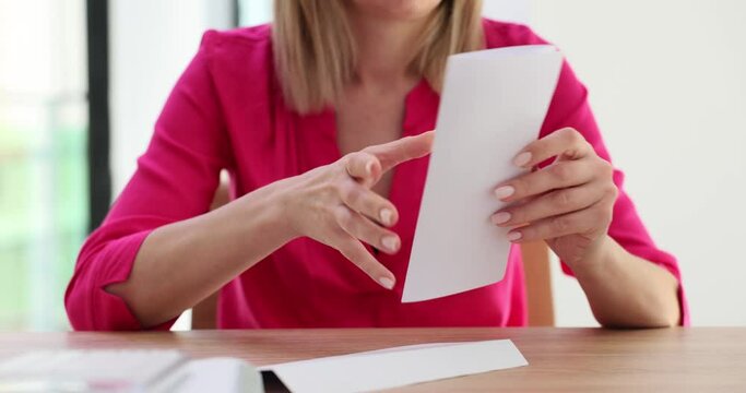 Female hands open envelope and read letter