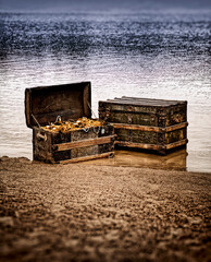 Two ornately decorated treasure chests, resting in the shallow waters of a tropical beach