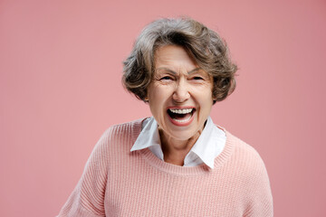 Smiling beautiful senior gray haired woman wearing casual clothes laughing looking at camera