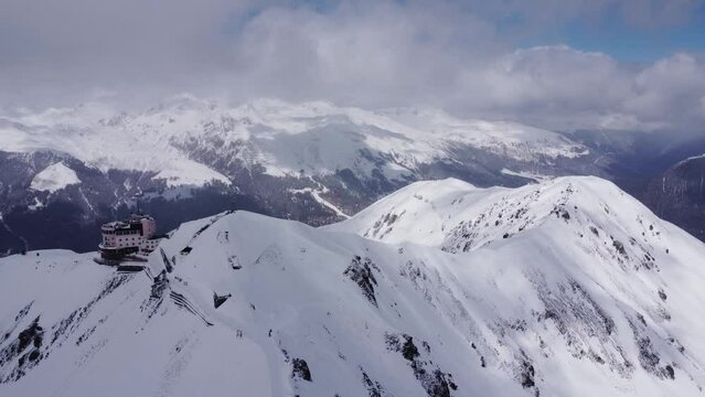 High altitude ski station building surrounded by clouds in the Swiss Alps