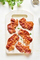  Crispy bacon on wooden cutting board