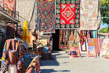 Turkish carpets. Street shop near Didyma Apollo Temple. Travelling and shopping, traditional handmade souvenirs. Didim (Aydin), Turkey (Turkiye) - obrazy, fototapety, plakaty