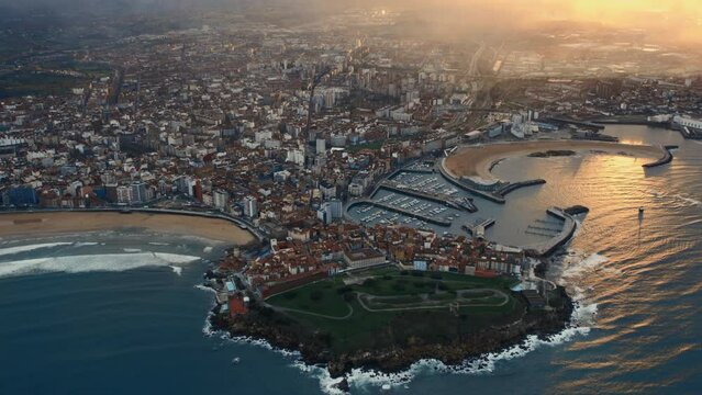 Drone point of view Gijon or Xixon city in north-western Spain during sunset, coast of Cantabrian Se, Bay of Biscay, in the central-northern part of Asturias. Travel destinations, landmarks concept