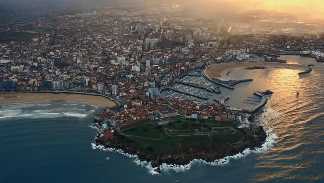 Drone point of view Gijon or Xixon city in north-western Spain during sunset, coast of Cantabrian Se, Bay of Biscay, in the central-northern part of Asturias. Travel destinations, landmarks concept