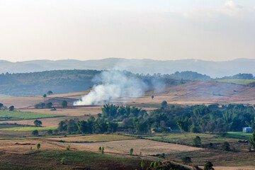 Landscape of fields and burning litter in Kalaw Hills