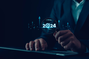 Business goals for 2024. Analytical businessman plans business growth for 2024, digital marketing...