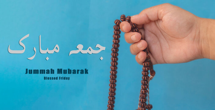 Jummah Mubarak blessed happy Friday Arabic Modern calligraphy, Selective focus image hand of Muslim woman holding prayer beads.