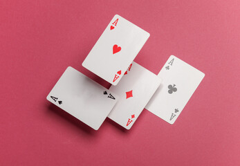 Four aces on a pink background