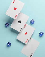 Fototapeta na wymiar Four aces and dice on a blue background