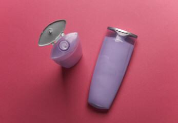 Shampoo bottles on pink background