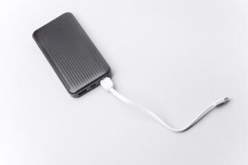 Black power bank with cable on a white background