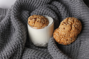 Cereal cookies in yogurt glass on gray fabric blanket