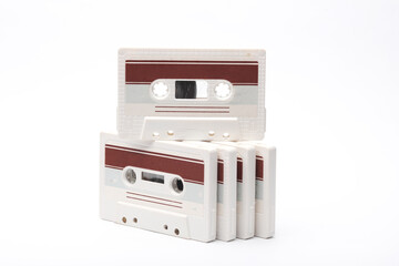 Fototapeta premium Stack of retro 80s audio cassettes on white background