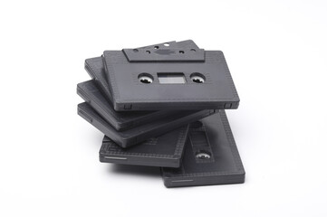 Stack of retro 80s audio cassettes on white background